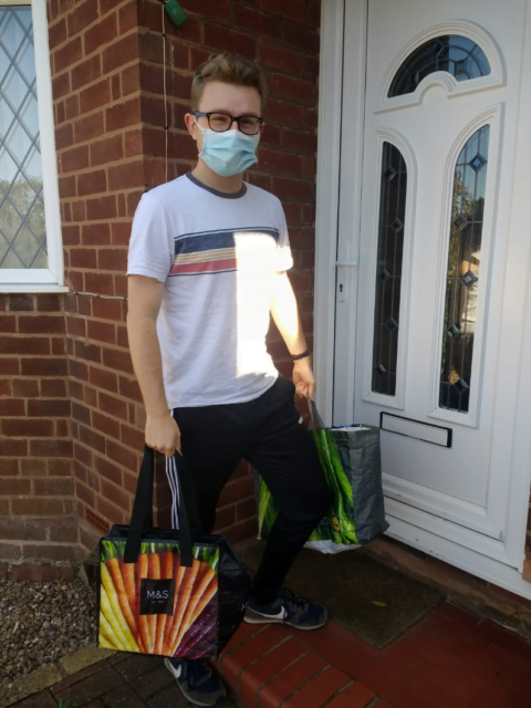 Boy with a face mask carrying a bag
